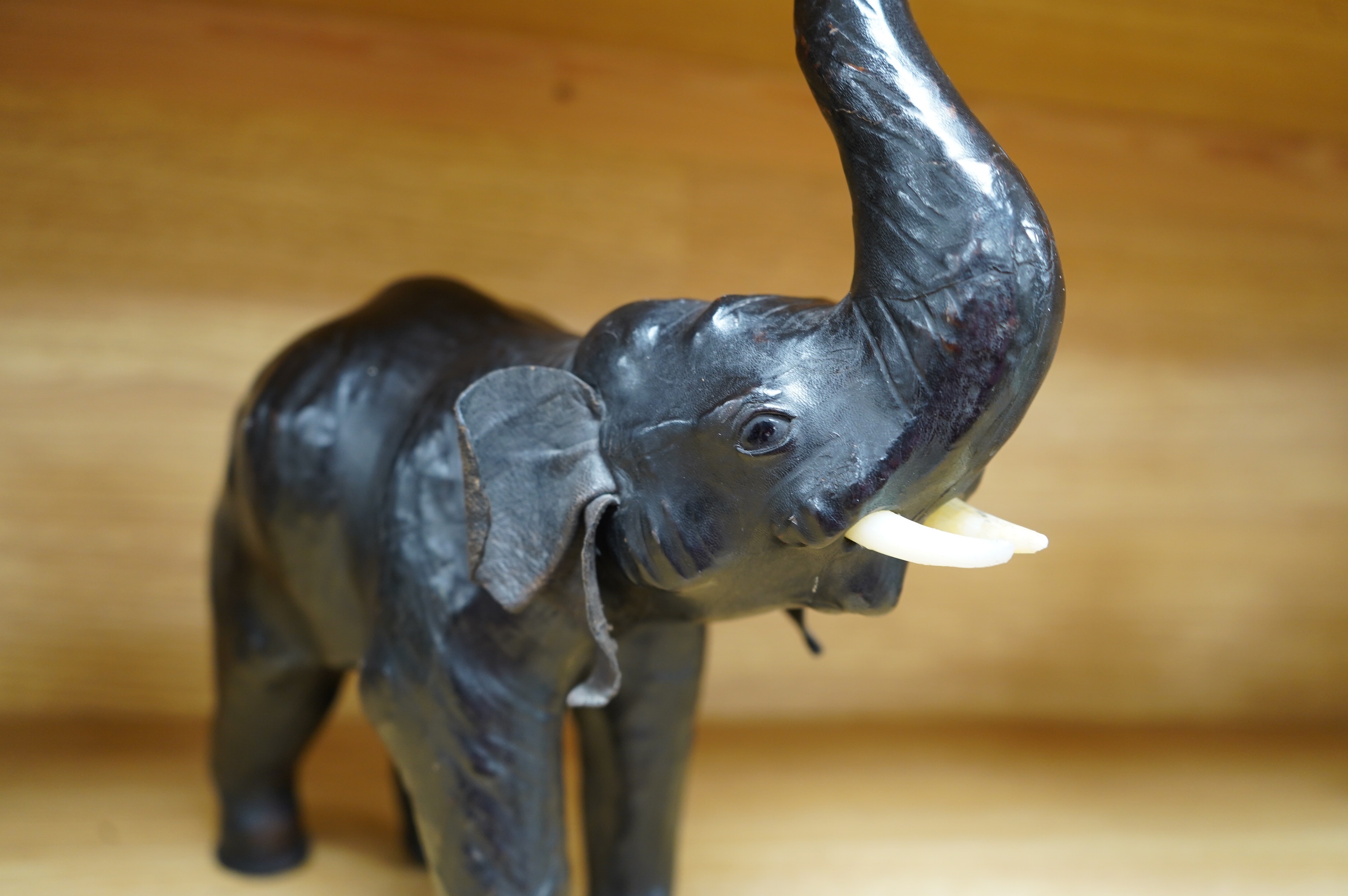 A small leather covered model of an elephant, stamped Liberty, 31cm. Condition - fair